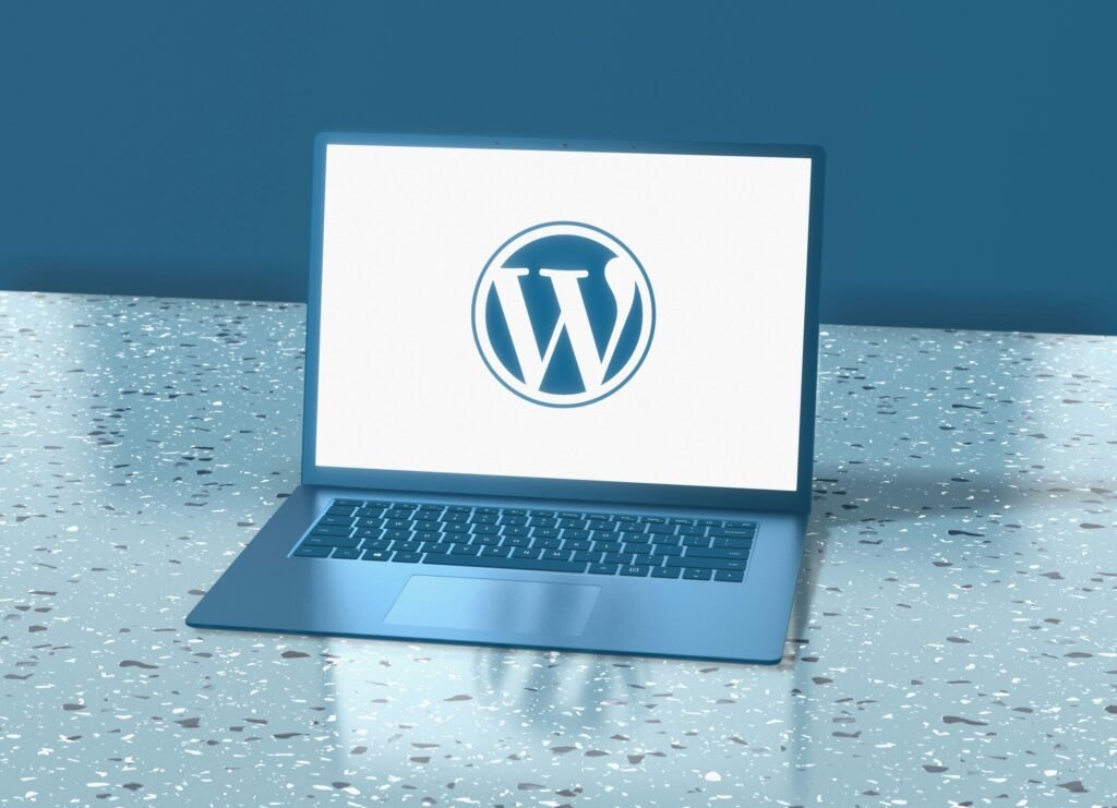 3D illustration of a laptop displaying the WordPress logo on a blue background